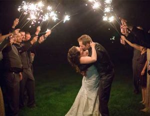 Wedding couple kissing under sparklers at sterling ridge