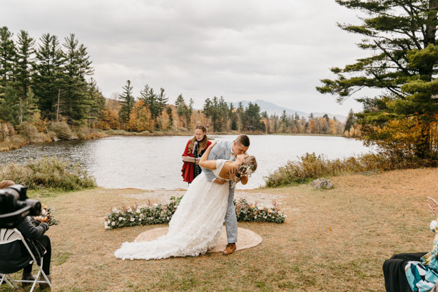 Couple's first kiss in front of the pond at Sterling Ridge Resort in Vermont